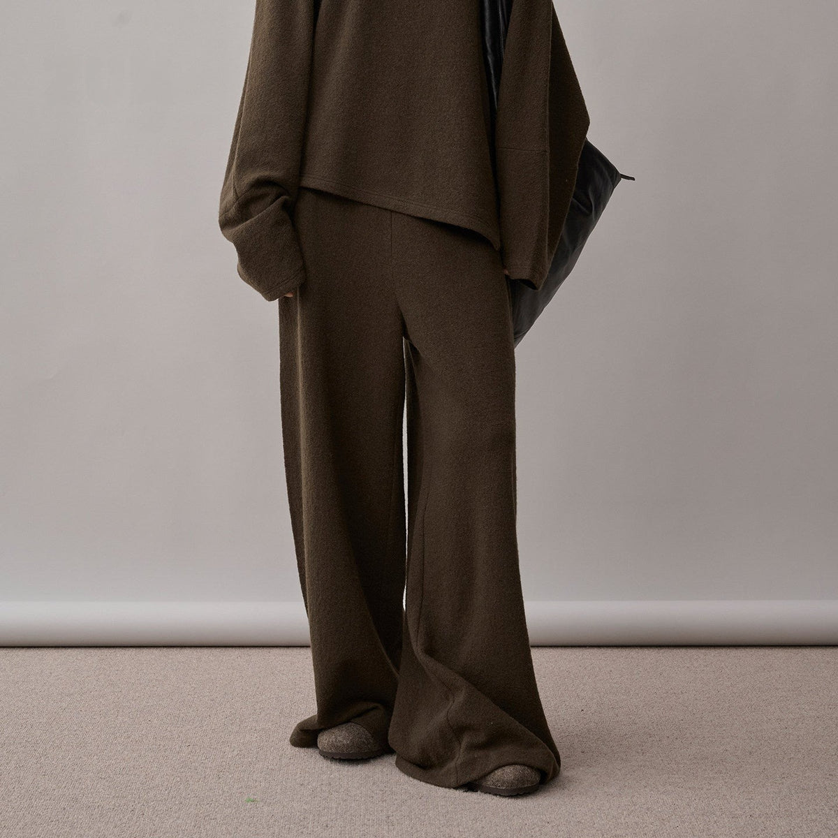 Dark brown wide-leg pants under the sweater hem, chest-to-floor view on model