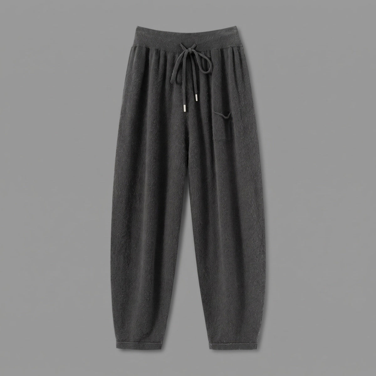 Cashmere joggers in charcoal, front view, on a grey studio backdrop