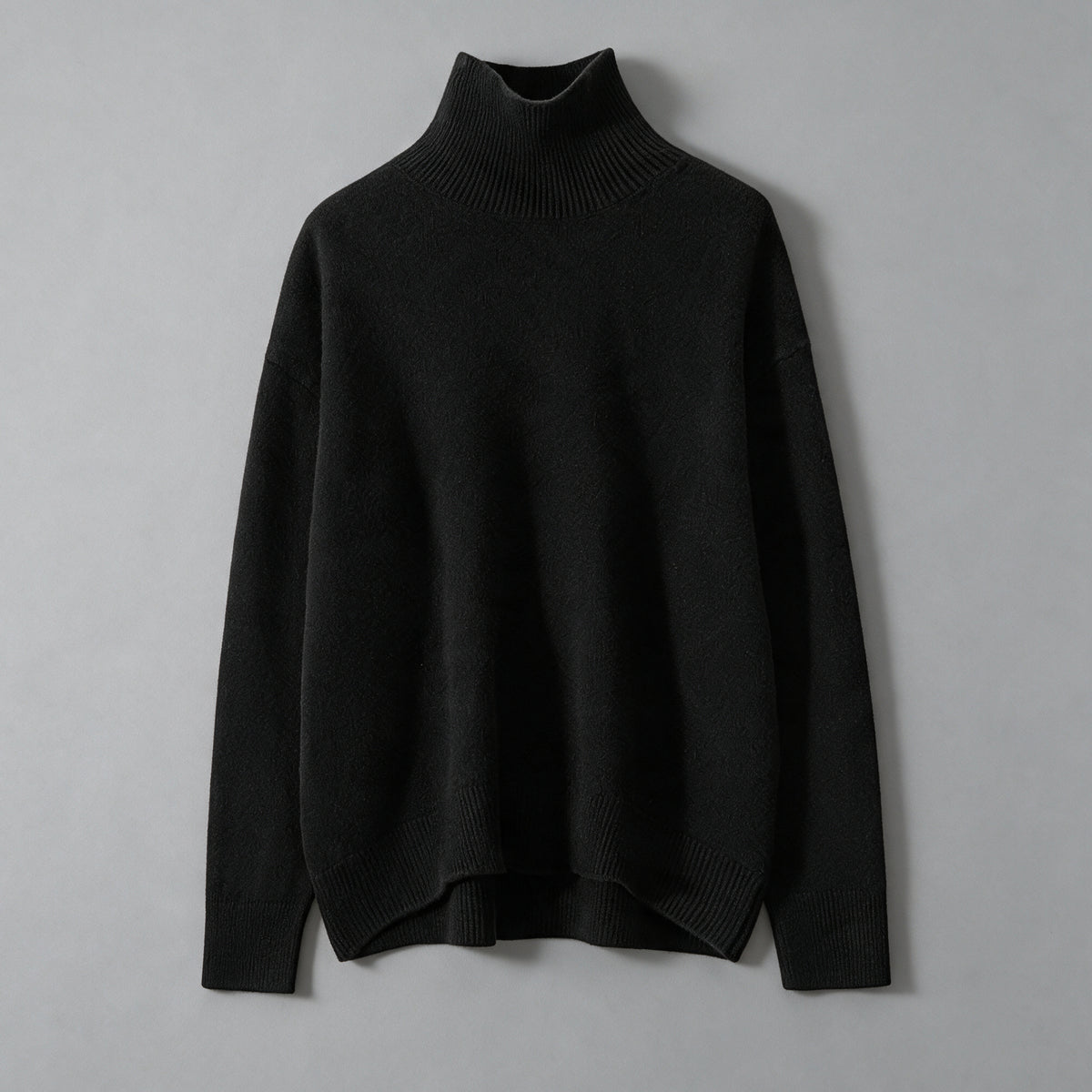 Black cashmere turtleneck sweater, front view, loose cut with a dropped shoulder