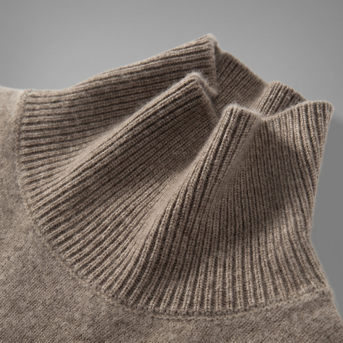 Ribbed collar of a brown cashmere turtleneck sweater, close-up