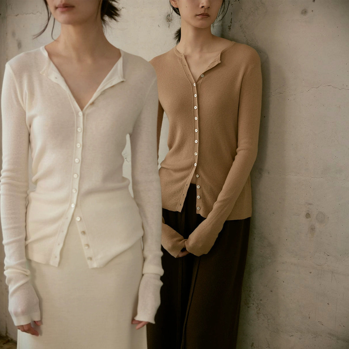 Sheer wool cardigan in cream and tan, two models standing side by side against a concrete wall