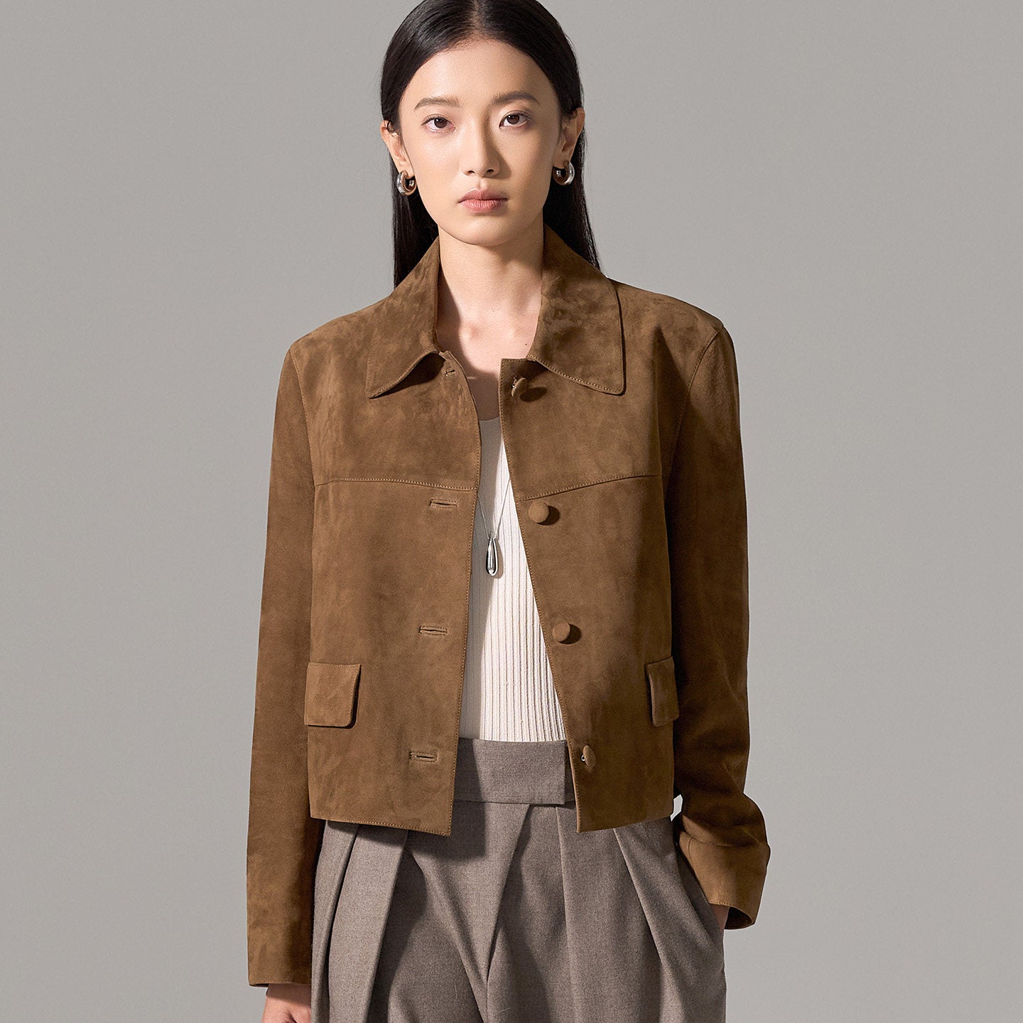 Cropped suede jacket detail, leather-covered horn buttons
