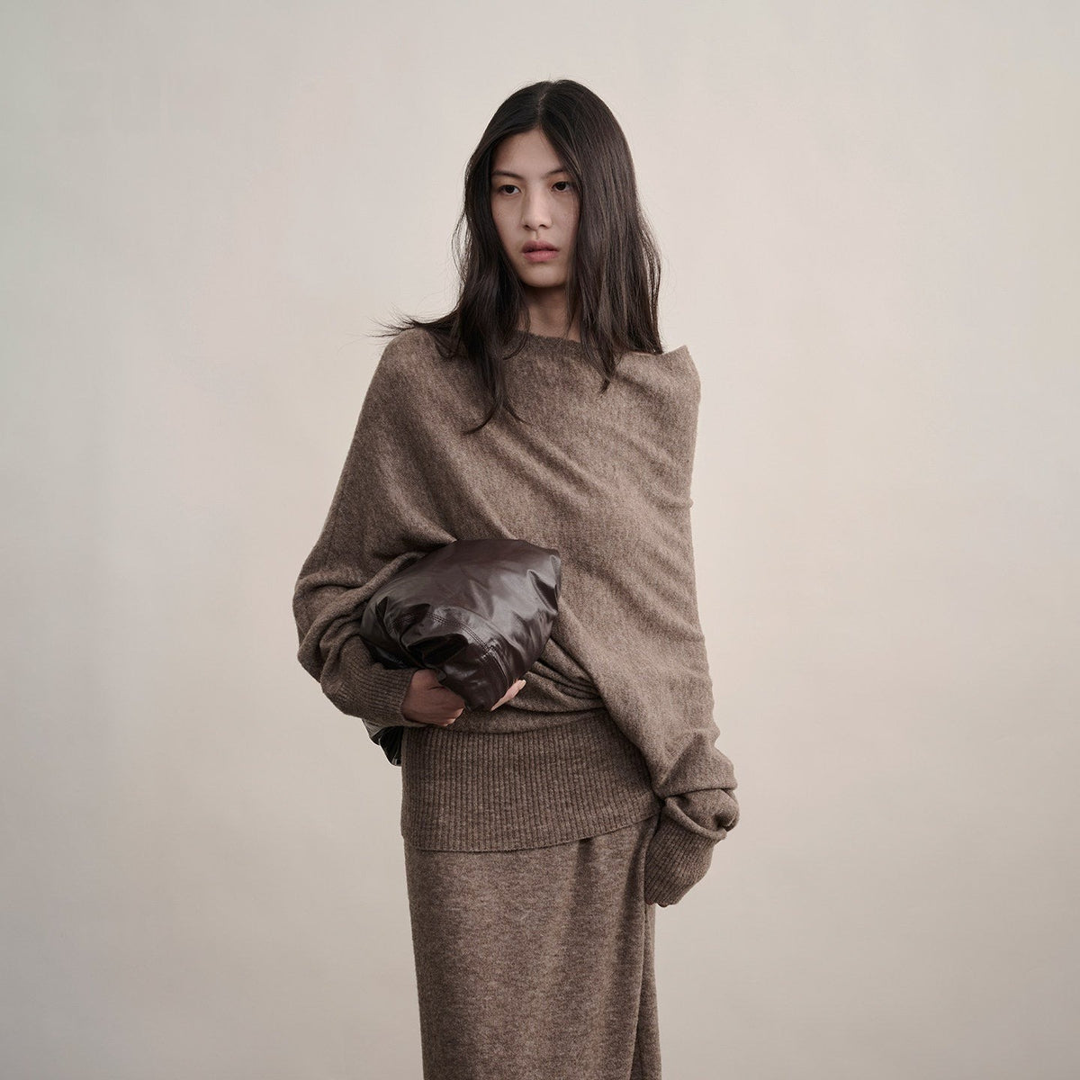Brown off-shoulder wool sweater with ribbed hem, upper-body view on model