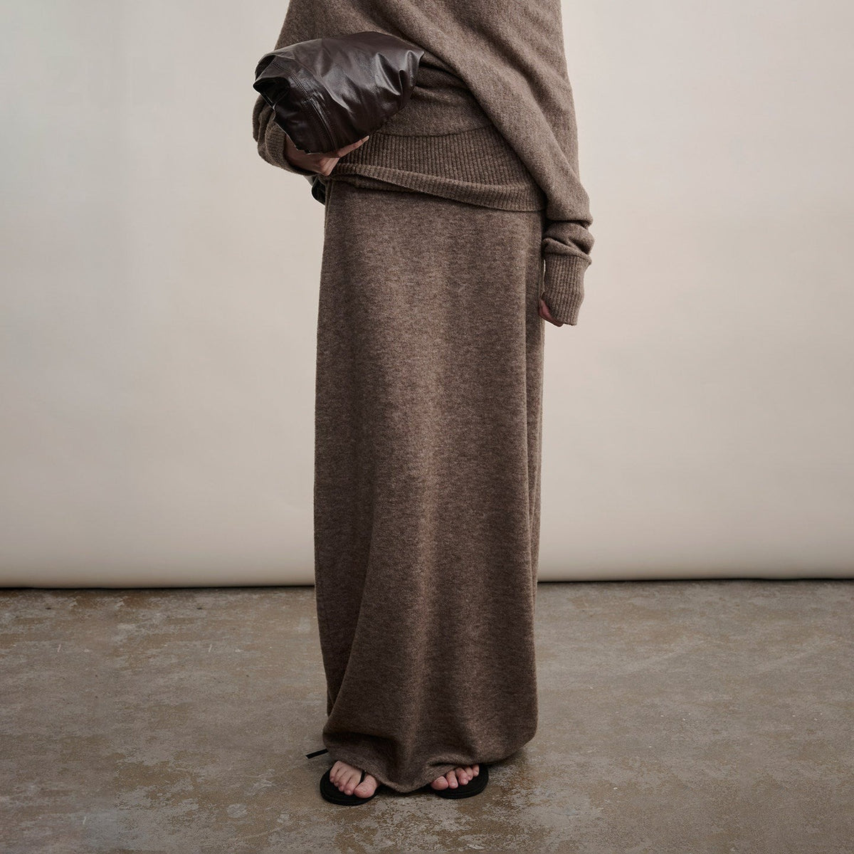 Brown long wool knit skirt, view from chest to floor on model