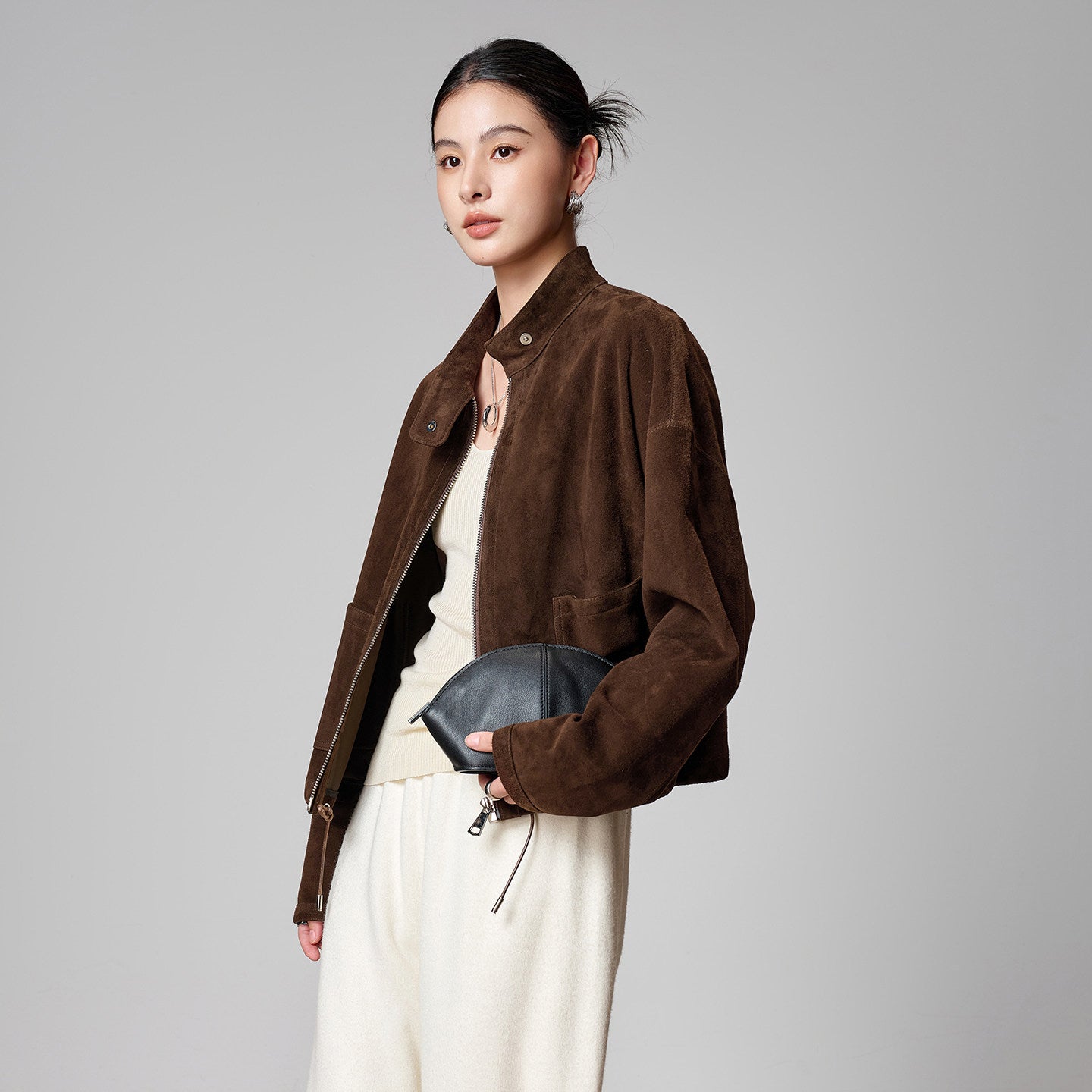 Detail of the brown suede funnel-neck jacket