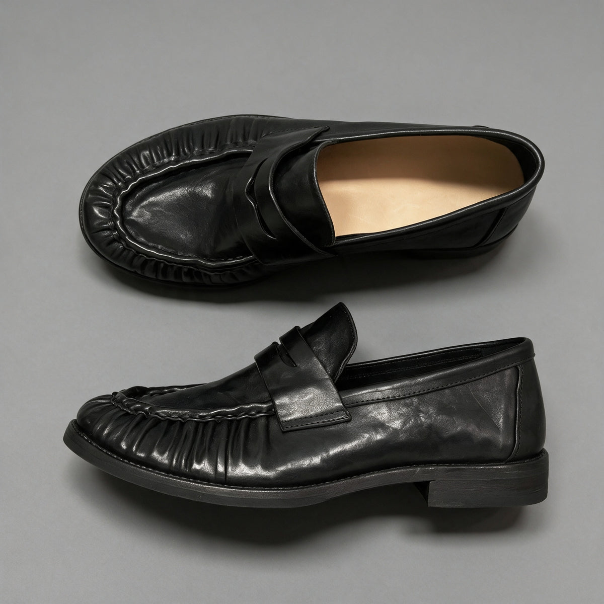 Jet penny loafers in washed horsehide, pair from above and the side