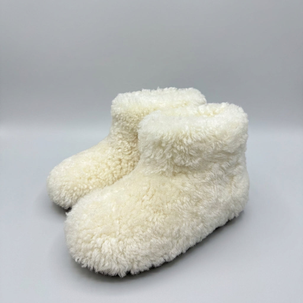 cream curly shearling ankle boots, three-quarter view of the pair