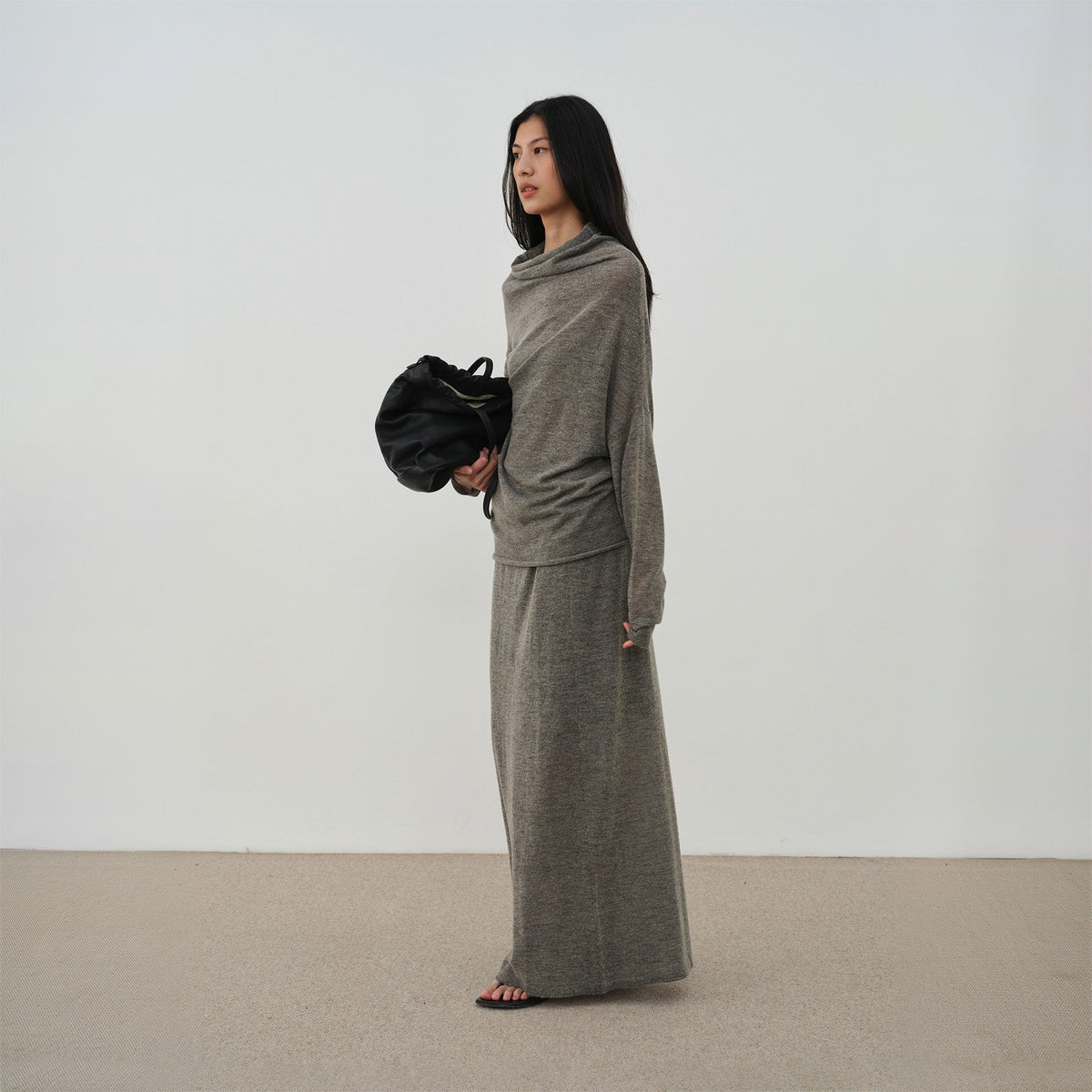 Oversized cowl neck sweater and long skirt in brown, side view on model