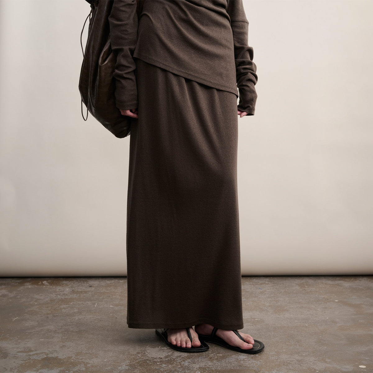 Brown cotton skirt with the top hem, view from chest to floor on model