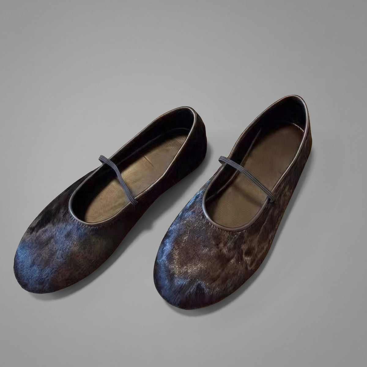 Horsehair mary jane flats in black, pair on a grey studio floor