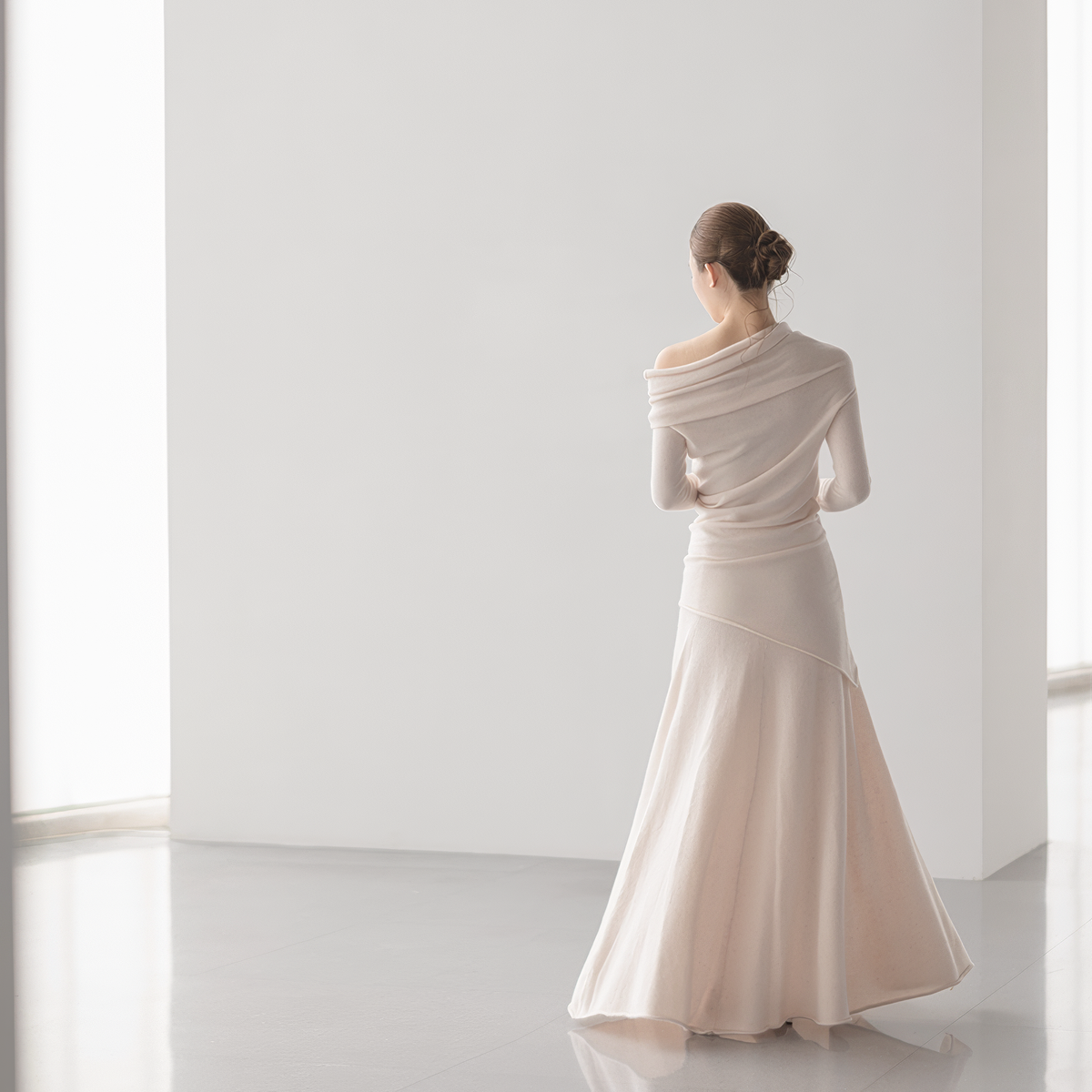 pale pink off-shoulder top and A-line skirt set, back view on model, skirt flaring at the hem