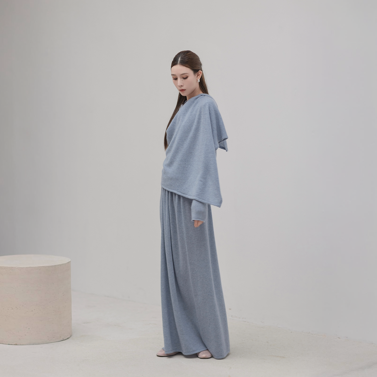 Scarf cape top and knit skirt set in grey-blue, three-quarter front view with the cape draped over one shoulder