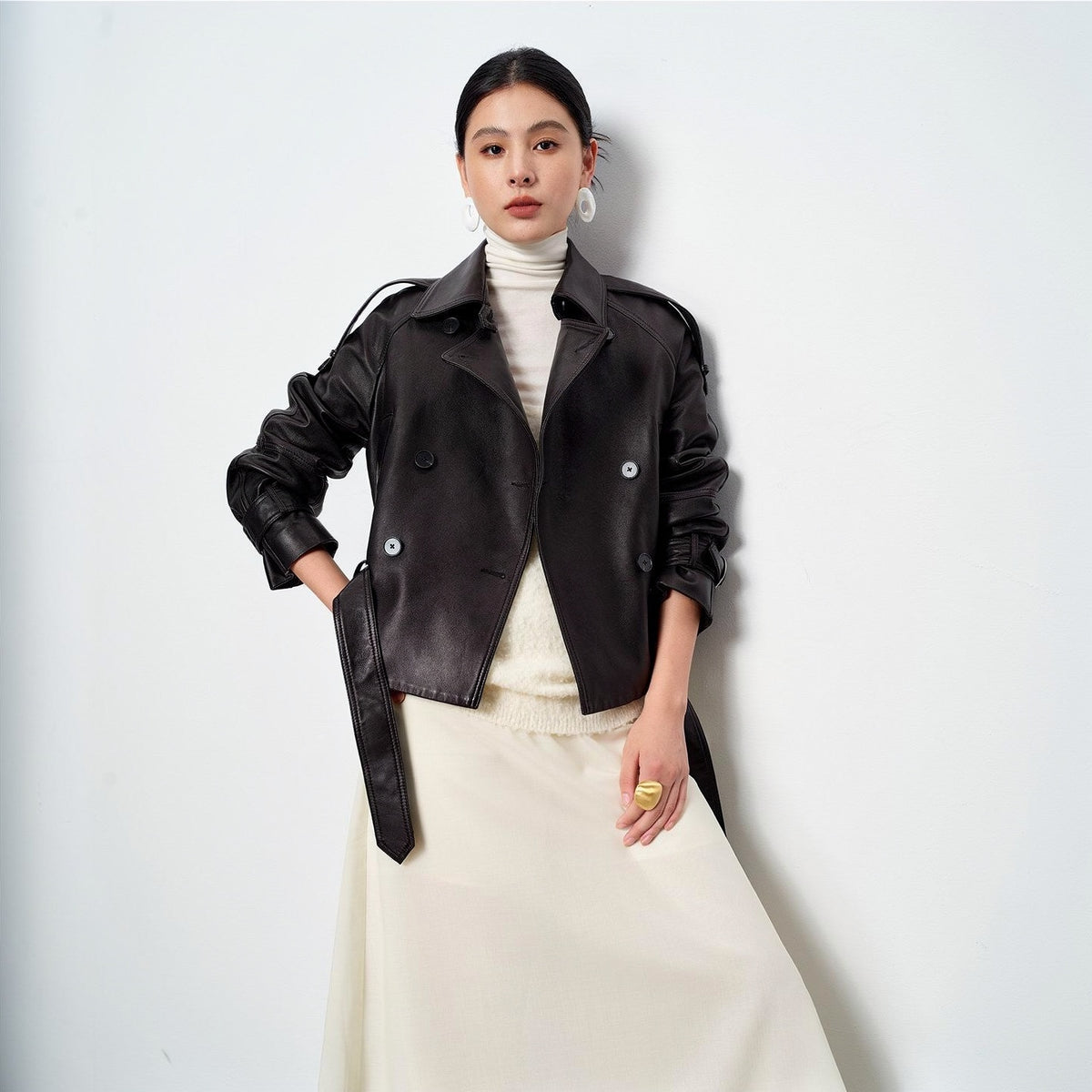 Vegetable-tanned sheepskin leather jacket in black, worn open over a cream knit