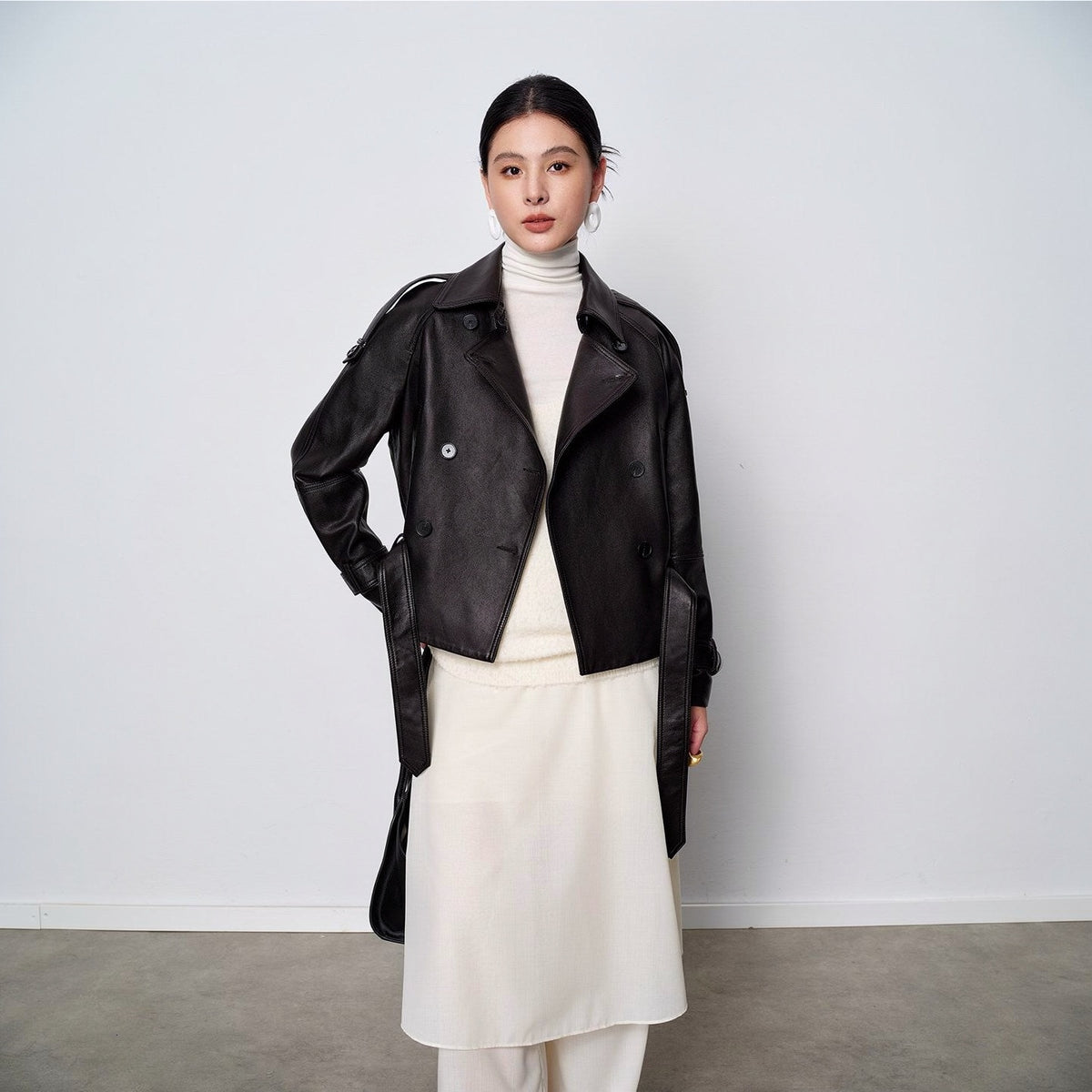 Vegetable-tanned sheepskin leather jacket in black, worn open with the tie belt hanging