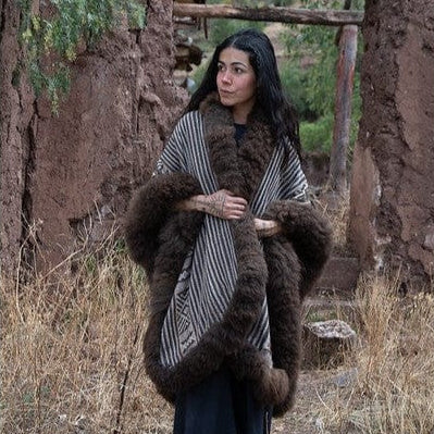 Front view of heritage fashion baby alpaca wool cape draped over cashmere sweater