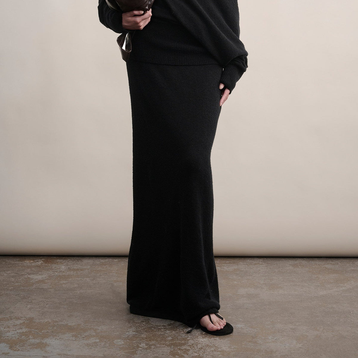 Black long wool knit skirt, view from waist to floor on model