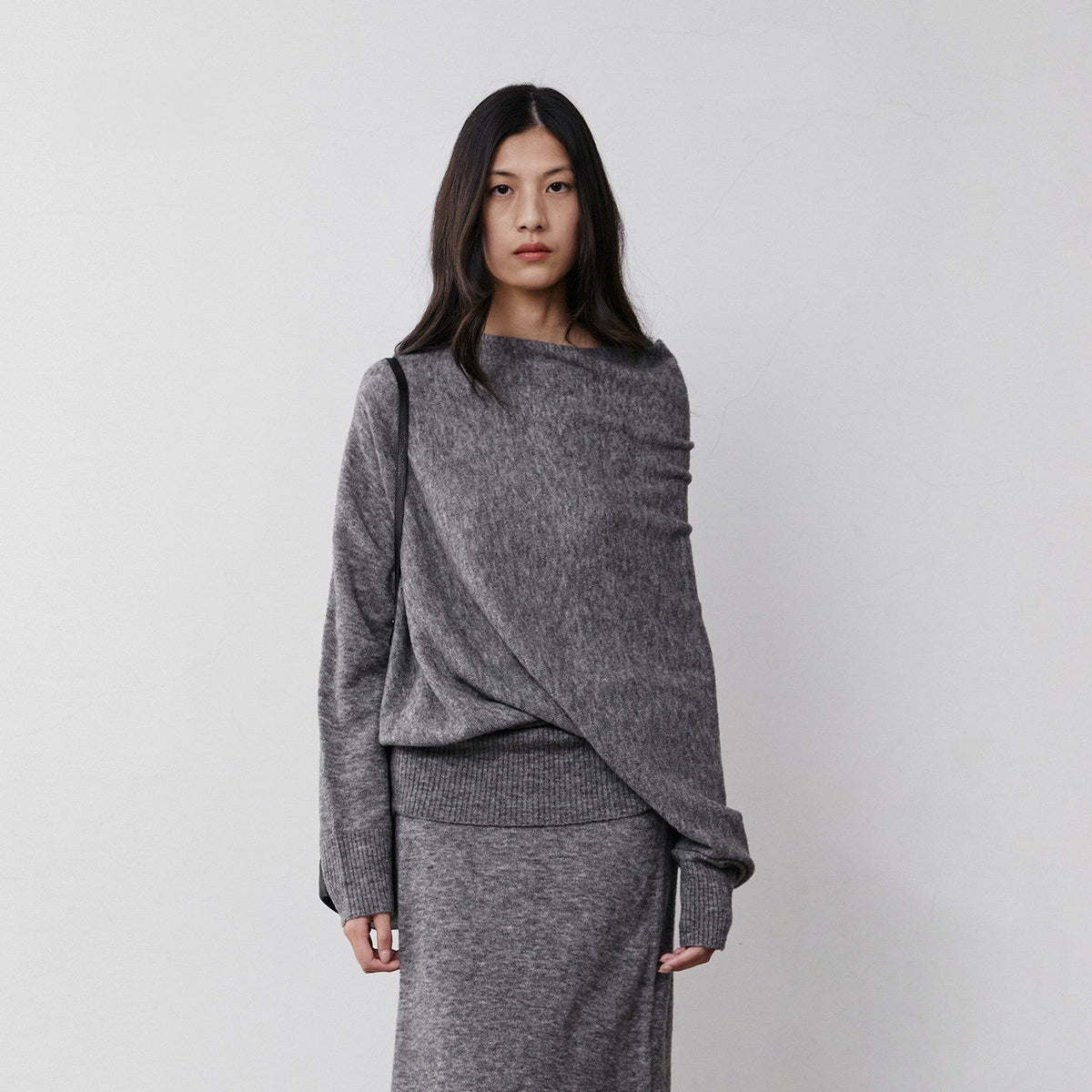 Charcoal heathered off-shoulder wool sweater with matching skirt, front view on model