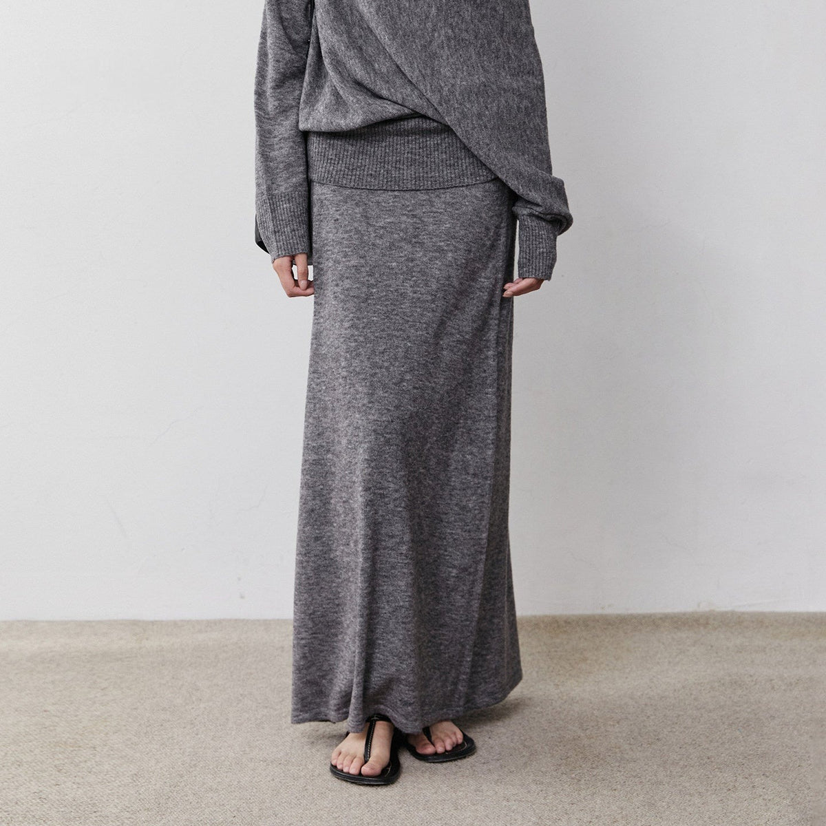 Charcoal heathered long wool knit skirt, view from waist to floor on model