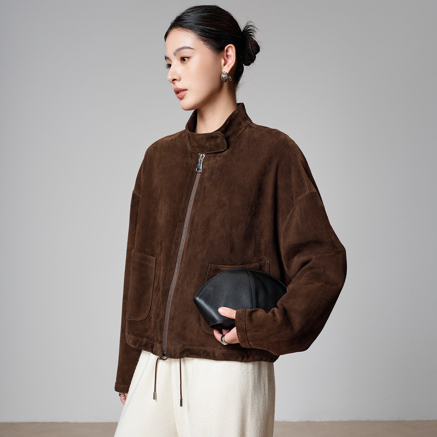 Close-up of the suede finish on the brown sheepskin funnel-neck jacket