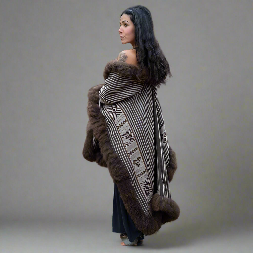 Side view of heritage fashion baby alpaca wool cape featuring fairly paid traditional artisans