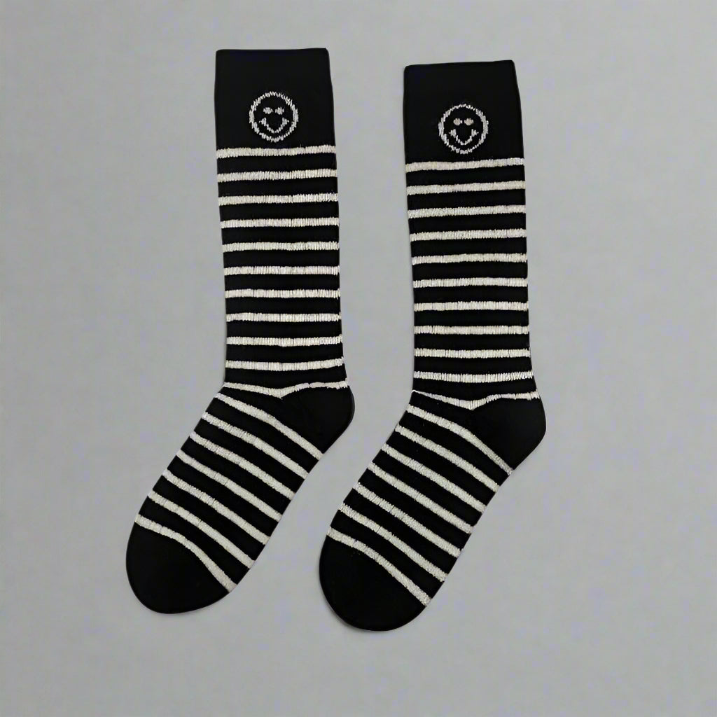 Soft, warm, and playfully striped cashmere socks—the perfect cozy essential.