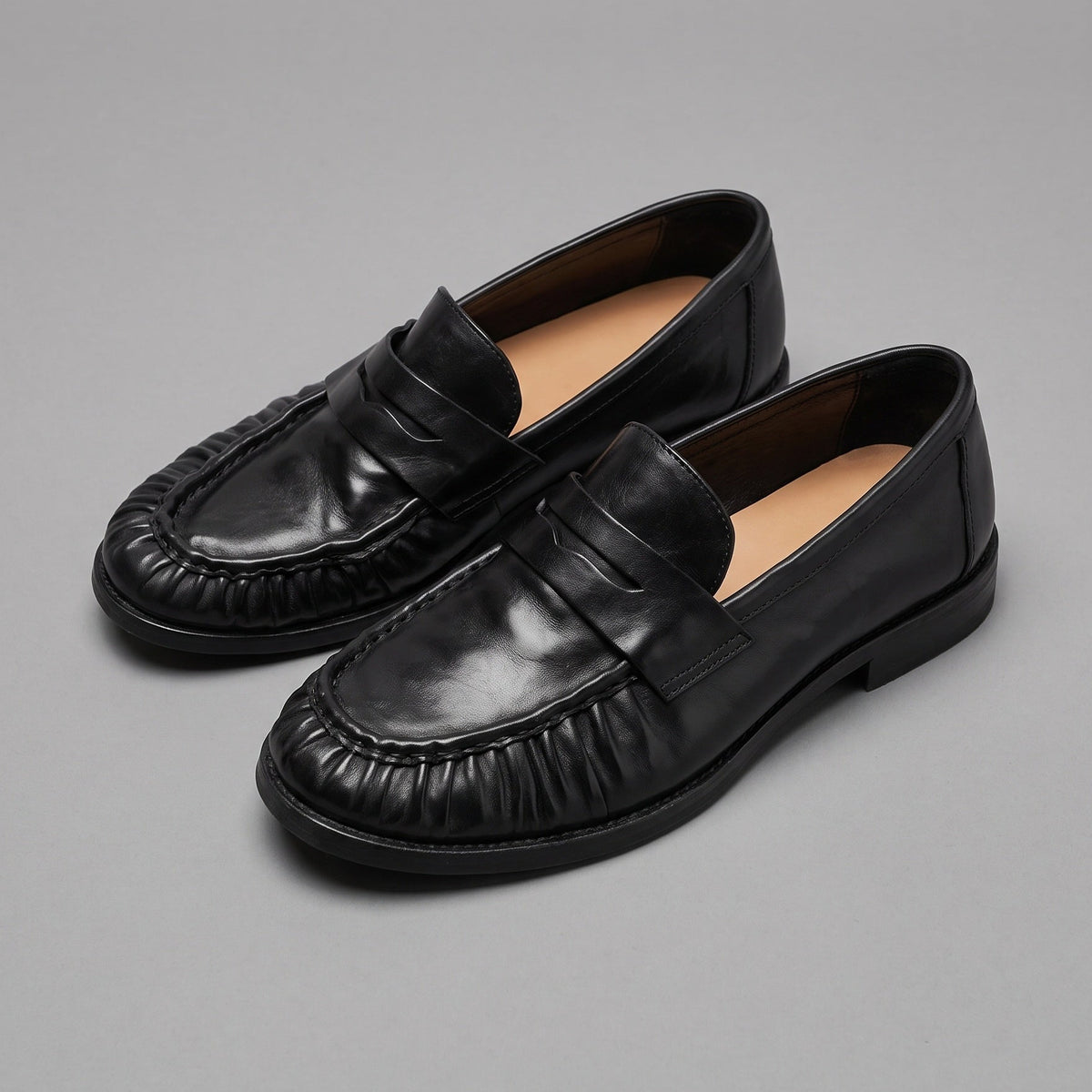 Jet penny loafers in washed horsehide, pair at an angle