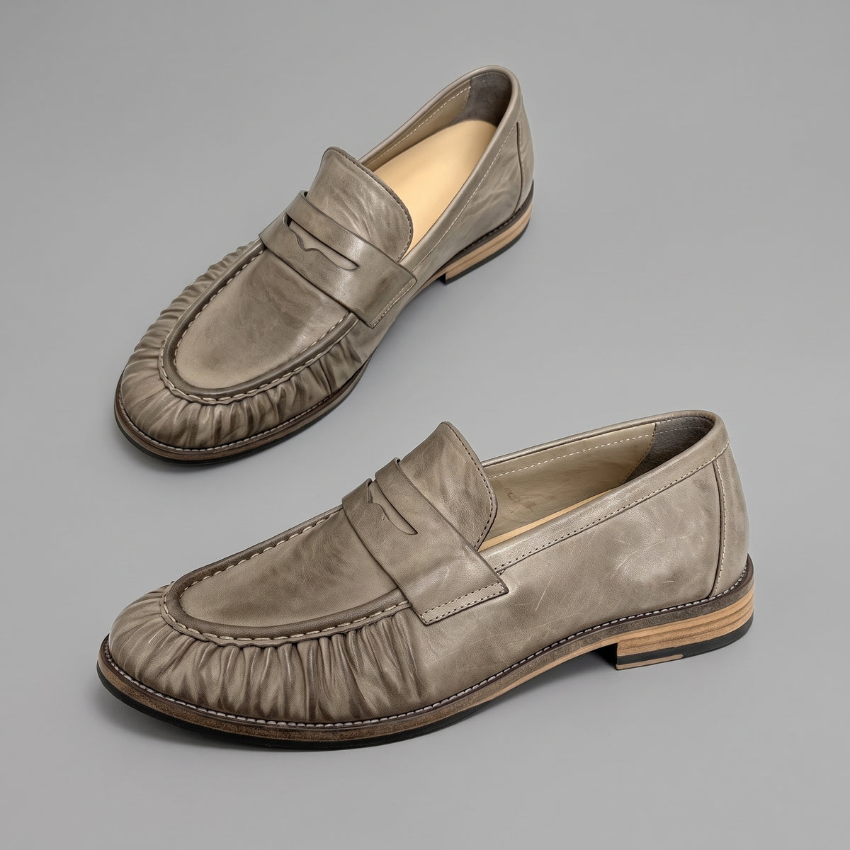 Truffle penny loafers in washed horsehide, pair from above and the side